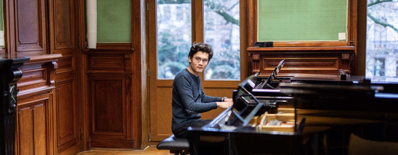 Foto van studerende student aan de piano